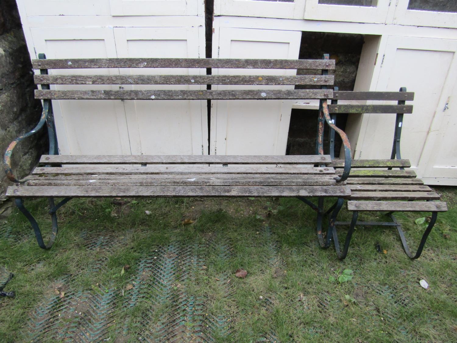 A three seat garden bench with weathered timber lathes and sprung steel supports, together with a