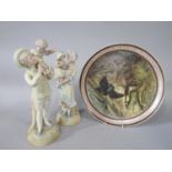 A pair of late 19th century continental bisque figures of a mother and father each holding a