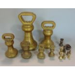 A graduated set of Avery type brass weighing scales, ranging from 7 lb down to 1/4 of an ounce,