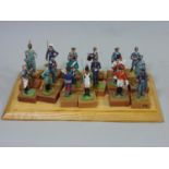 Presentation case displaying 18 individual standing figures of historical soldier figures in