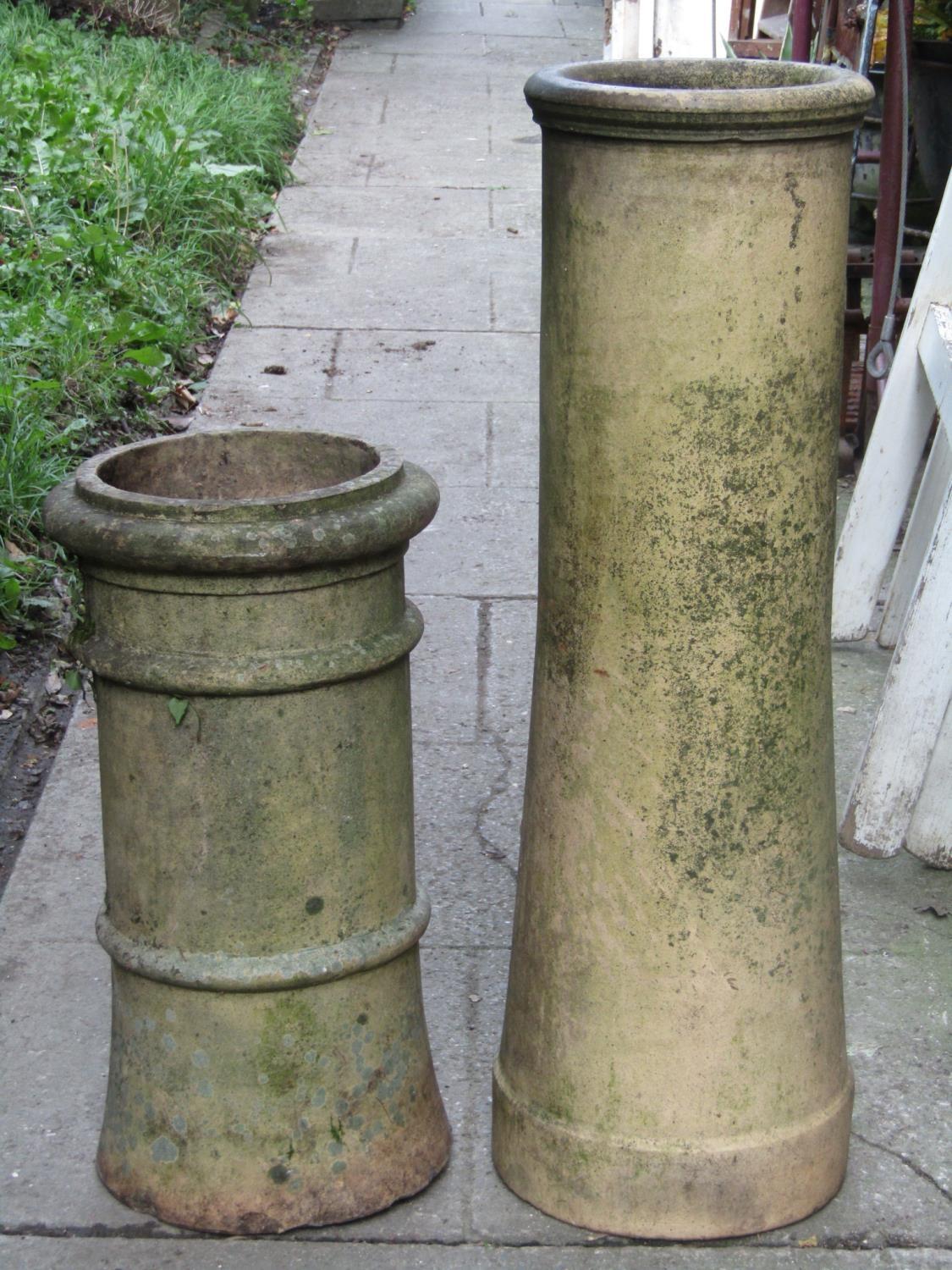 Two reclaimed buff coloured chimney pots of cylindrical form (varying design and height), the