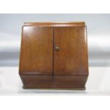 Late 19th century oak sloped desk top cabinet, the hinged front enclosing a waterfall interior,