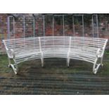 A good quality sprung steel and strap work cream painted garden bench of unusual curved form with