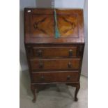 A 1920s walnut veneered ladies writing bureau, the fall flap enclosing a simply fitted interior over