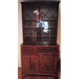 A Georgian mahogany secretaire bookcase, enclosed by a pair of panelled doors, enclosing two open