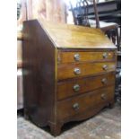 A Georgian oak countrymade bureau of four long graduated drawers, the fall flap enclosing a fitted