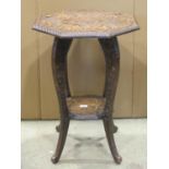 A Japanese carved soft wood occasional table of octagonal form with scrolling dragon, chip carved
