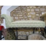 A Victorian chaise lounge/day bed with scrolled head rest, upholstered in light green ground