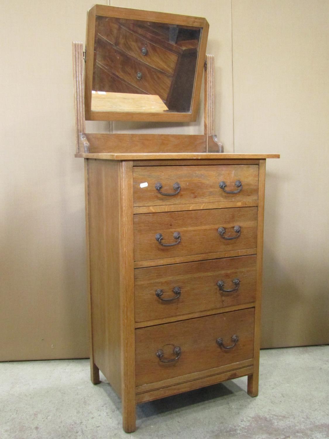 A small Edwardian/1920s stripped oak dressing chest of four long drawers, beneath a rectangular