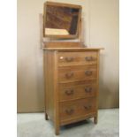 A small Edwardian/1920s stripped oak dressing chest of four long drawers, beneath a rectangular