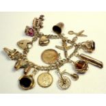 9 CT GOLD CHARM BRACELET COMPRISING AN EDWARD VII 1905 HALF-SOVEREIGN AND FOURTEEN 9 CT GOLD CHARMS,