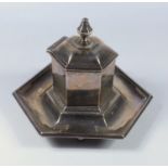 LATE VICTORIAN SILVER HEXAGONAL INKSTAND WITH A HINGED COVER AND SILVER MOUNTED GLASS LINER, ON