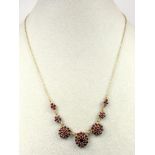 EASTERN GOLD AND GARNET NECKLACE WITH SEVEN SEPARATE GARNET CLUSTERS, (L. 43 CM), GROSS 9.2 GRAMS