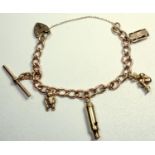 9 CT GOLD CHARM BRACELET WITH FIVE CHARMS, 28.9 GRAMS