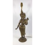 EASTERN BRASS FIGURE OF A SEMI-CLAD WOMAN STANDING ON A PIERCED CIRCULAR BASE, ADAPTED TO A TABLE