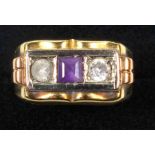 YELLOW METAL RING SET AMETHYST AND TWO WHITE STONES, STAMPED 750, GROSS 6.2 GRAMS.