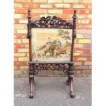 VICTORIAN CARVED OAK FIRESCREEN WITH GLAZED PETIT POINT PANEL WITH A GIRL ON A HORSE, MAN AND