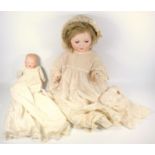 GERMAN BISQUE HEADED GIRL DOLL WITH ROLLING BLUE EYES, ARTICULATED COMPOSITION LIMBS AND BLOND