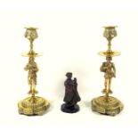 PAIR OF LATE 19TH CENTURY CONTINENTAL CAST BRASS CANDLESTICKS, EACH COLUMN AS A FIGURE IN MEDIEVAL