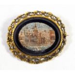 ITALIAN MICRO MOSAIC OVAL BROOCH DEPICTING ST. MARKS SQUARE IN A PIERCED GILT METAL SCROLLING LEAF