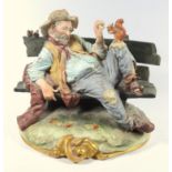 CAPODIMONTE PORCELAIN PAINTED GROUP, OF A TRAMP SITTING ON A BENCH FEEDING A RED SQUIRREL, SIGNED