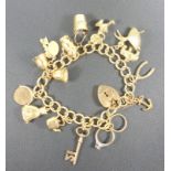 9 CT GOLD CHARM BRACELET WITH FIFTEEN CHARMS, CASED, 31.7 GRAMS