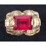 YELLOW METAL RING SET RECTANGULAR CUT RED STONE, 9 X 7 MM APPROX., GROSS 6.3 GRAMS.