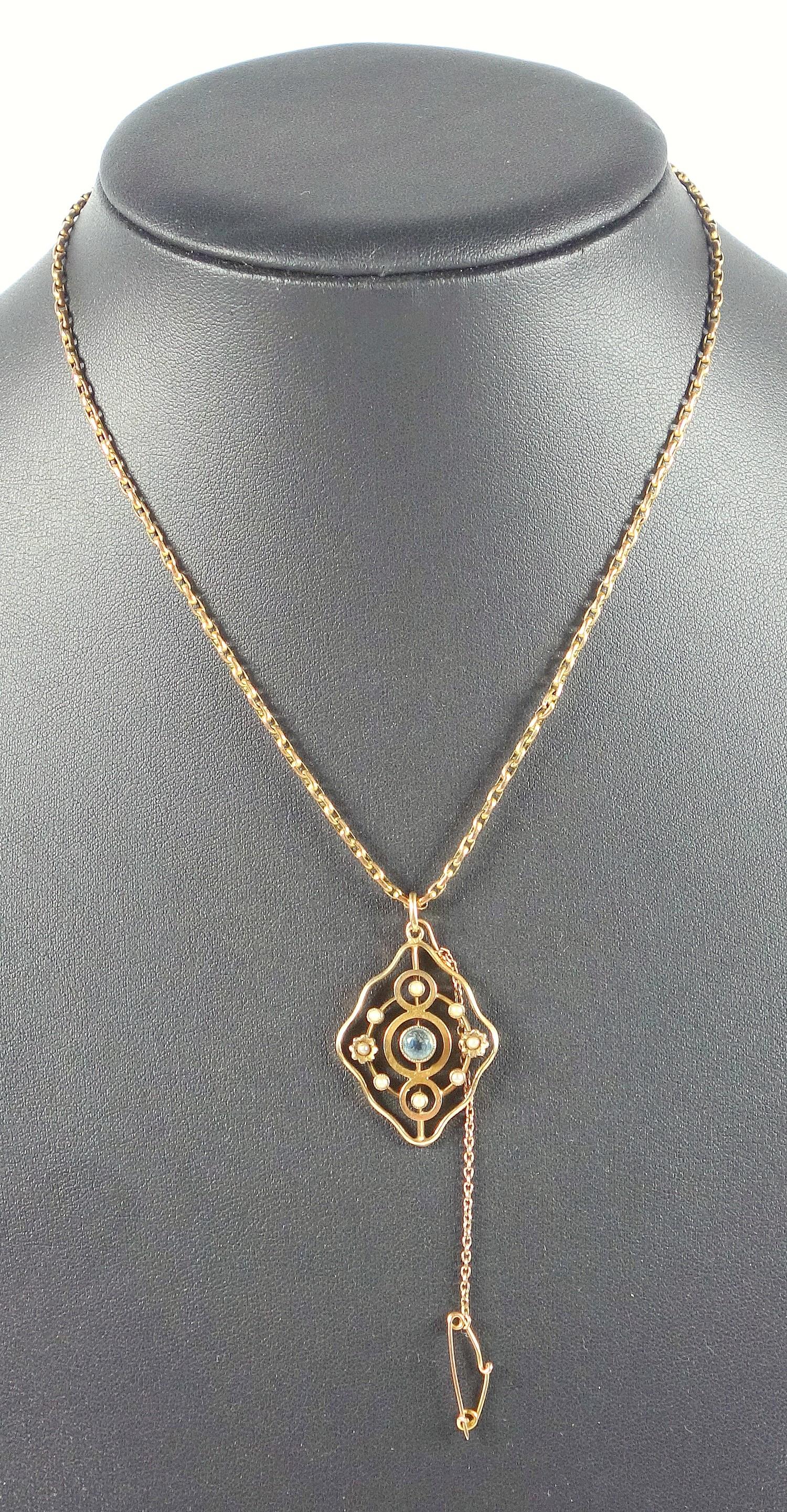 EDWARDIAN 9 CT GOLD OPENWORK PENDANT SET AQUAMARINE AND SEED PEARLS ON A 9 CT CHAIN, WITH SAFETY