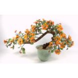 A CHINESE GLASS MODEL OF A FLOWERING TREE IN A CELADON POT (H. 31 CM)