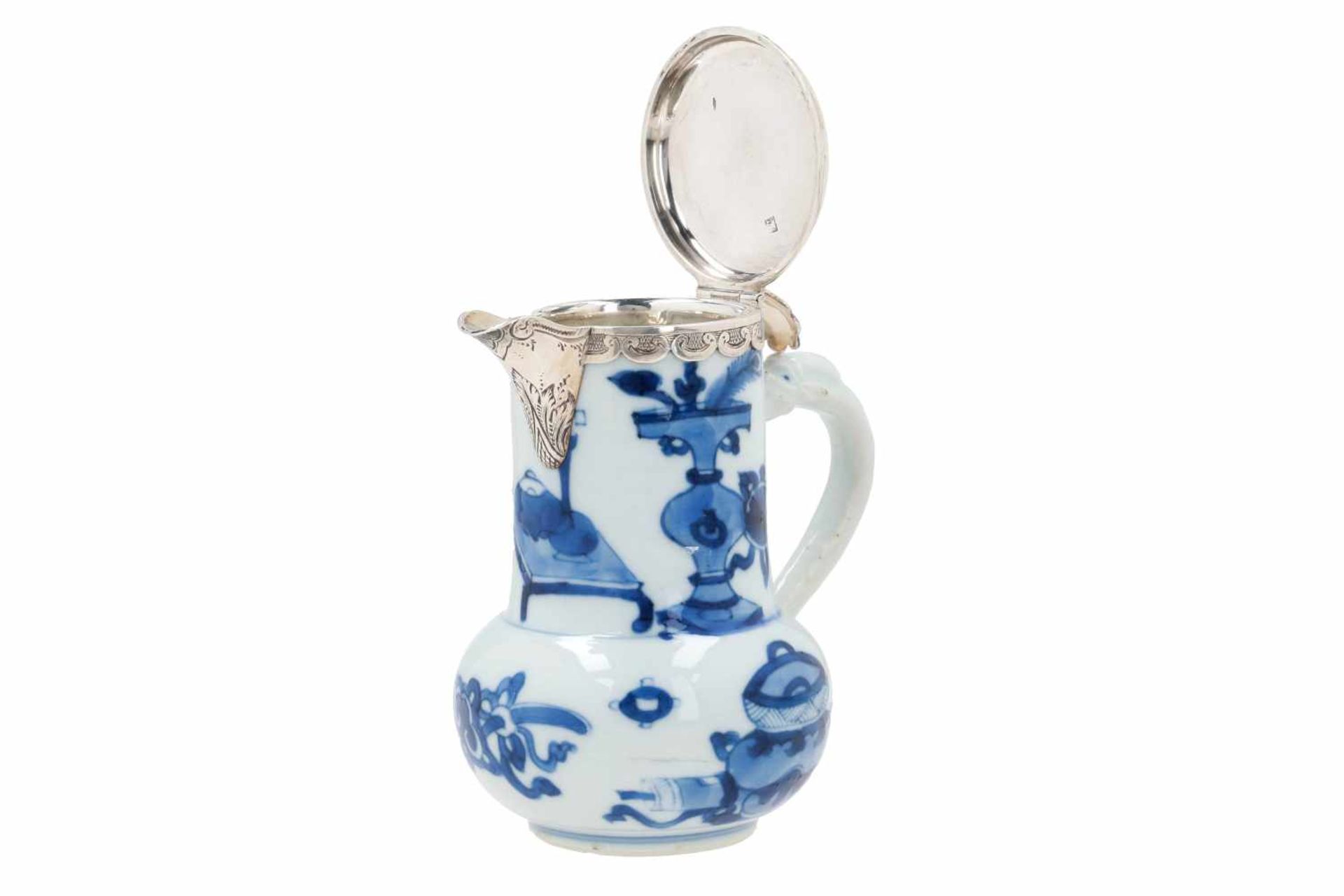 A blue and white porcelain jug with silver mounting, decorated with antiquities. Unmarked. China,