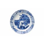 A blue and white porcelain dish, decorated with long Eliza on a bench in a garden. Marked with 6-