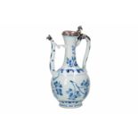 A blue and white porcelain jug with silver mounting, decorated with flowers and leaves. Unmarked.