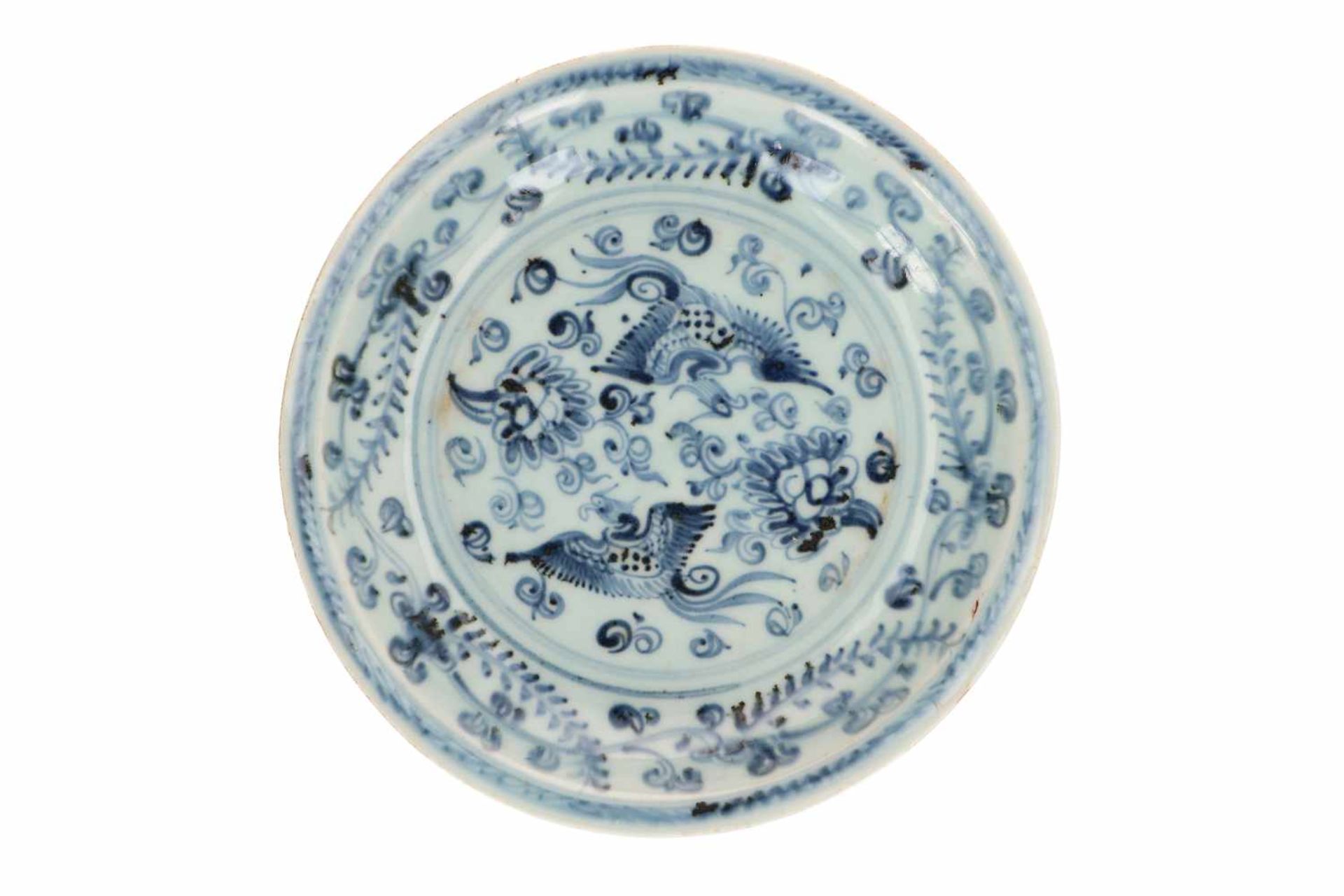A blue and white porcelain deep dish, decorated with two phoenixes among flowering plants. Unmarked.