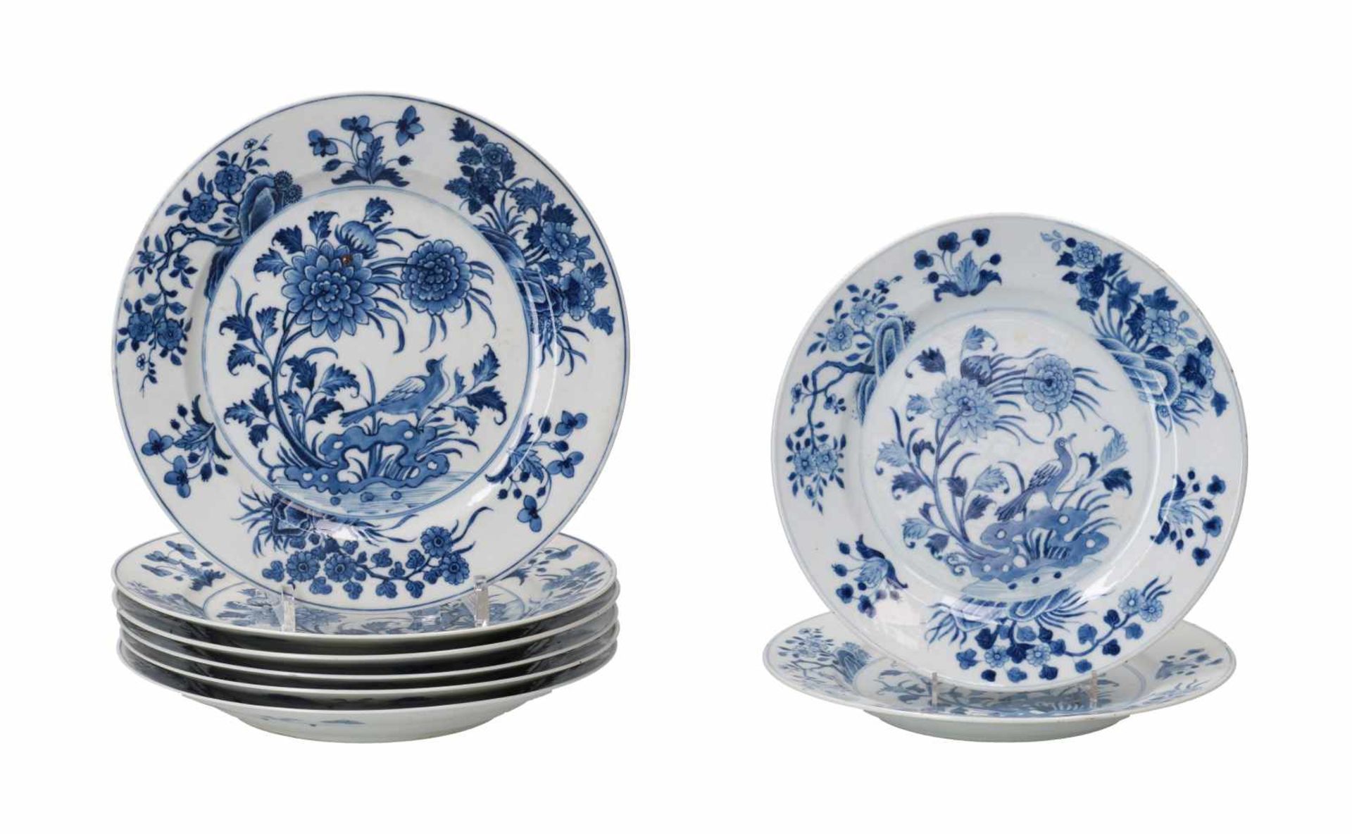 A set of eight blue and white porcelain dishes, decorated with a bird and flowers. Marked with 6-