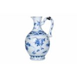 A blue and white porcelain jug with silver mounting, decorated with flowers. Unmarked. China,