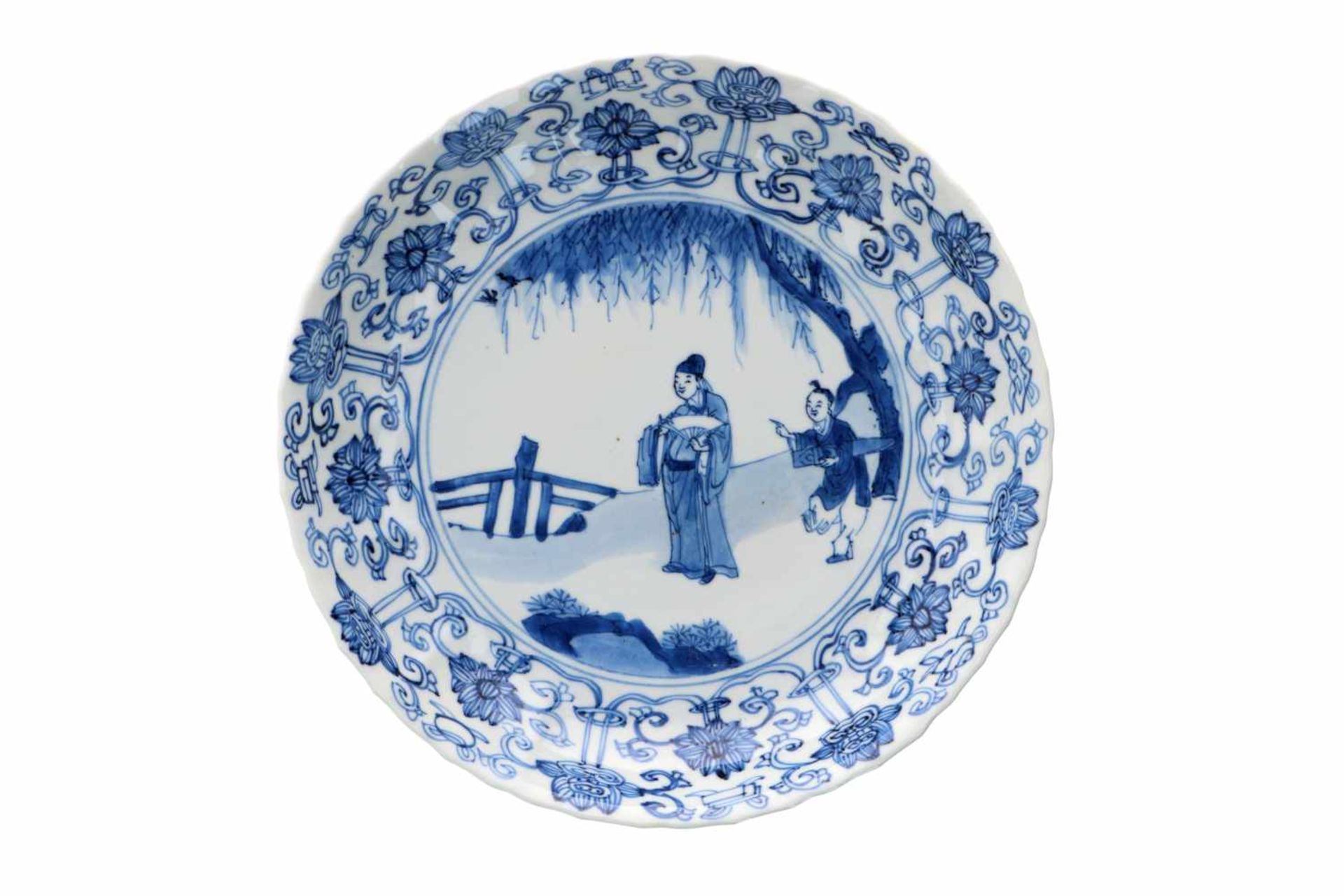 A lobed blue and white porcelain deep dish with scalloped rim, decorated with a dignitary and