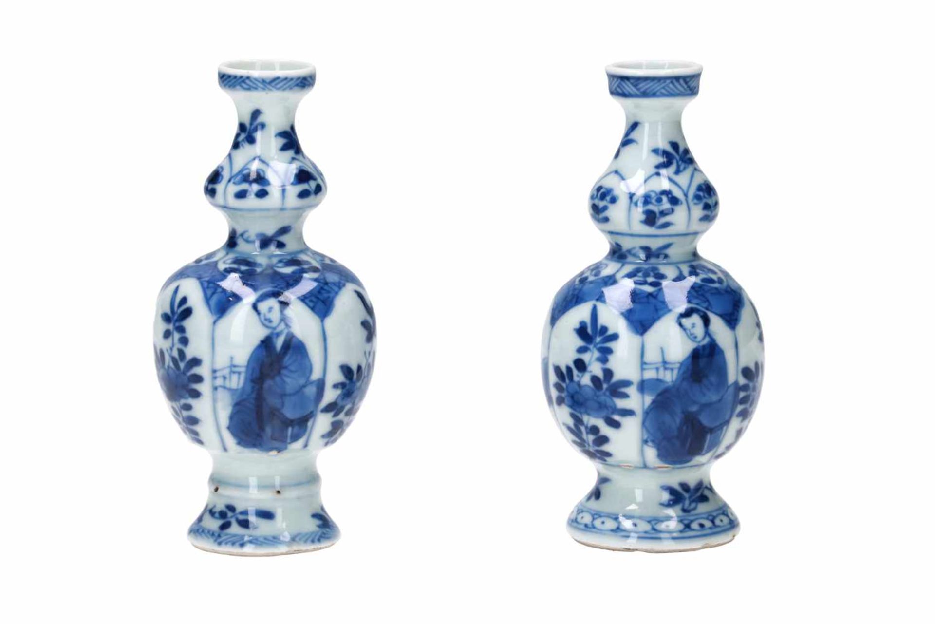 A pair of blue and white porcelain miniature vases, decorated with long Elizas and flowers. Marked