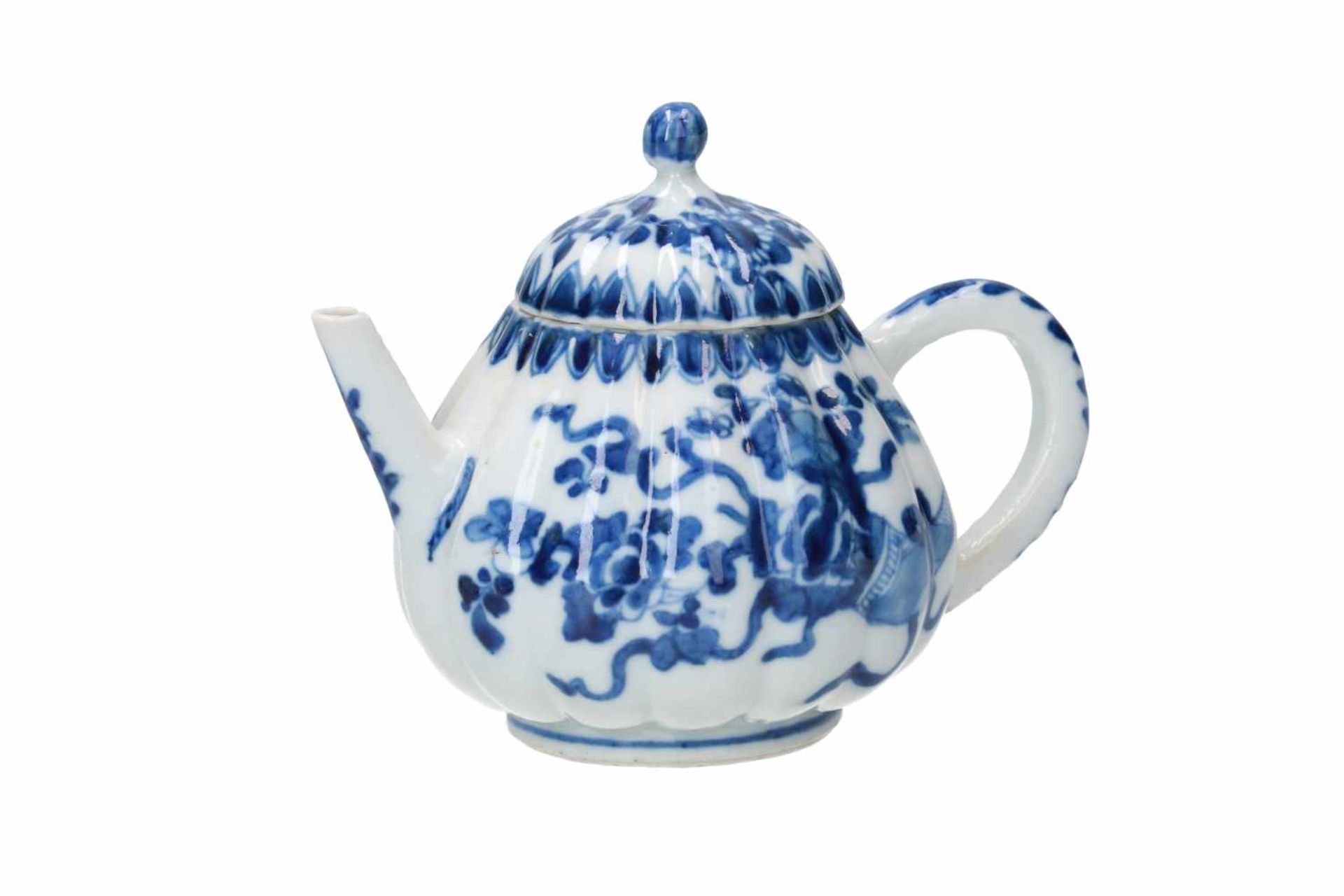 A blue and white porcelain teapot with lobed belly and cover, decorated with flowers. Unmarked.