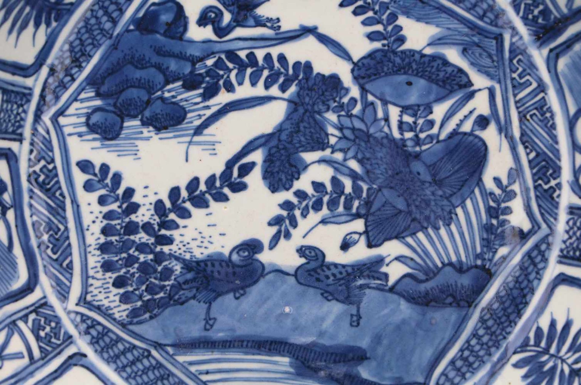 A blue and white porcelain charger, decorated with water birds and reserves depicting peaches and - Image 3 of 3