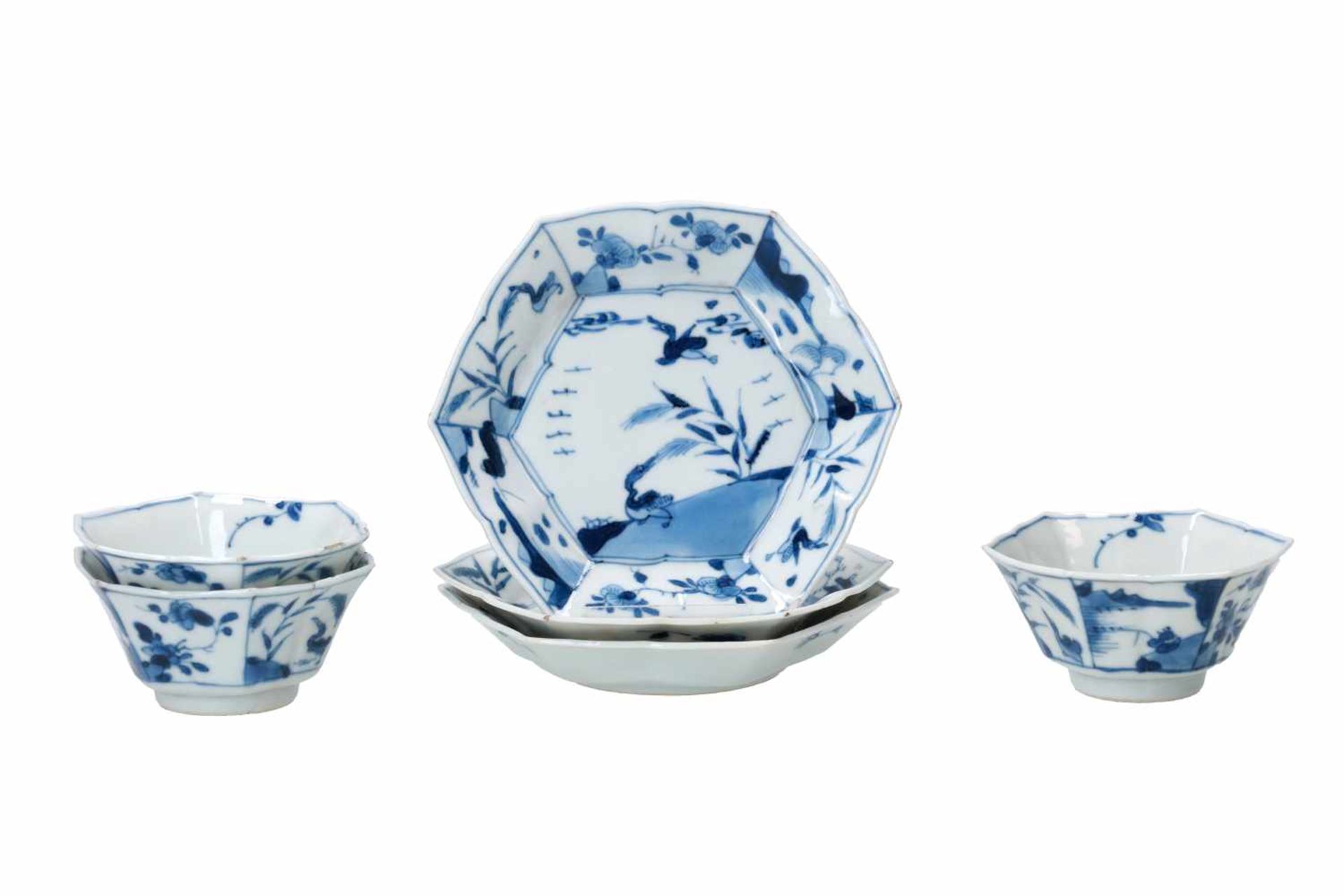 A set of three hexagonal blue and white porcelain cups with saucers, decorated with ducks, flowers