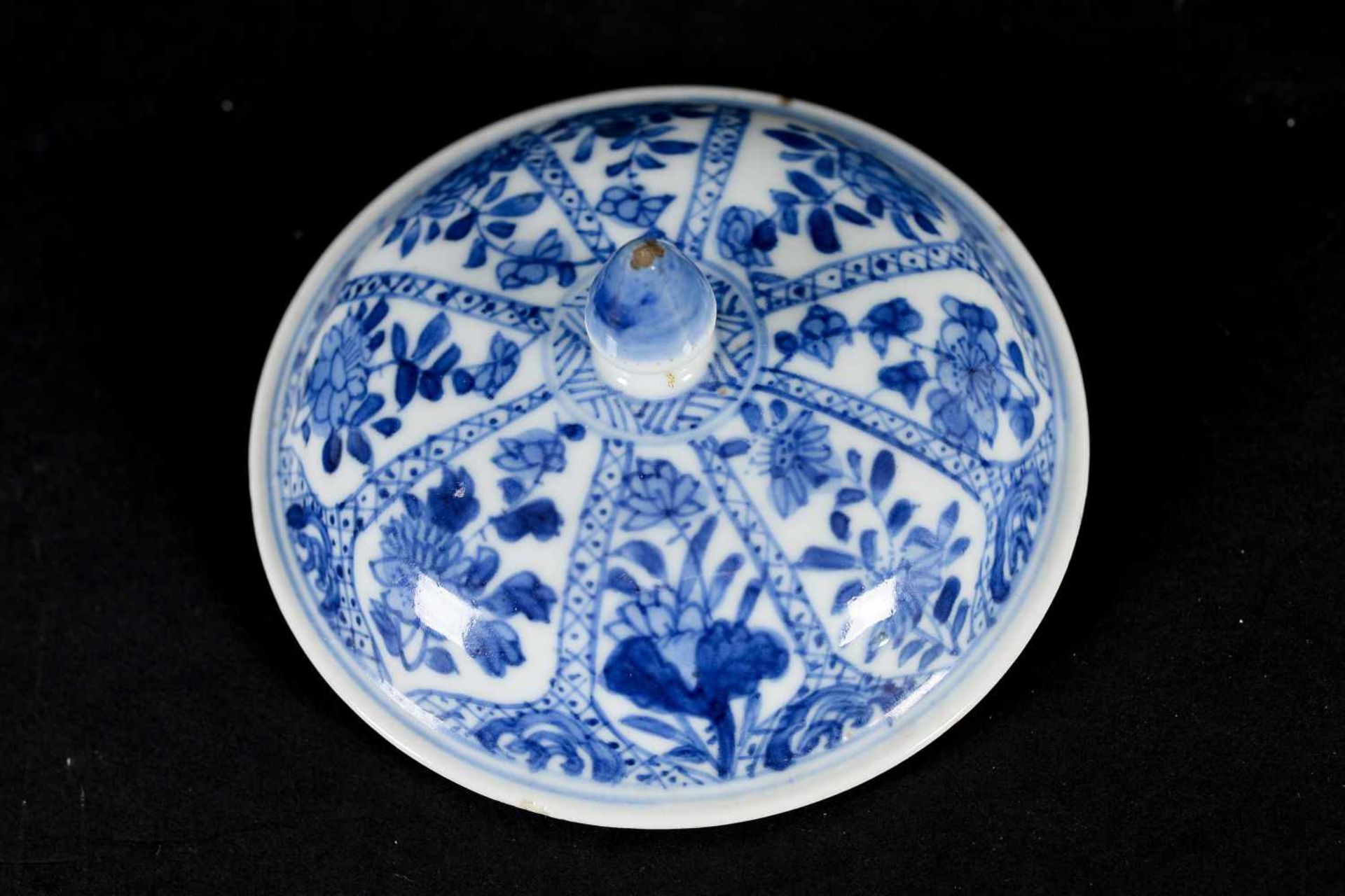 A blue and white porcelain lidded cup with two handles on a deep saucer, decorated with flowers. - Image 6 of 9