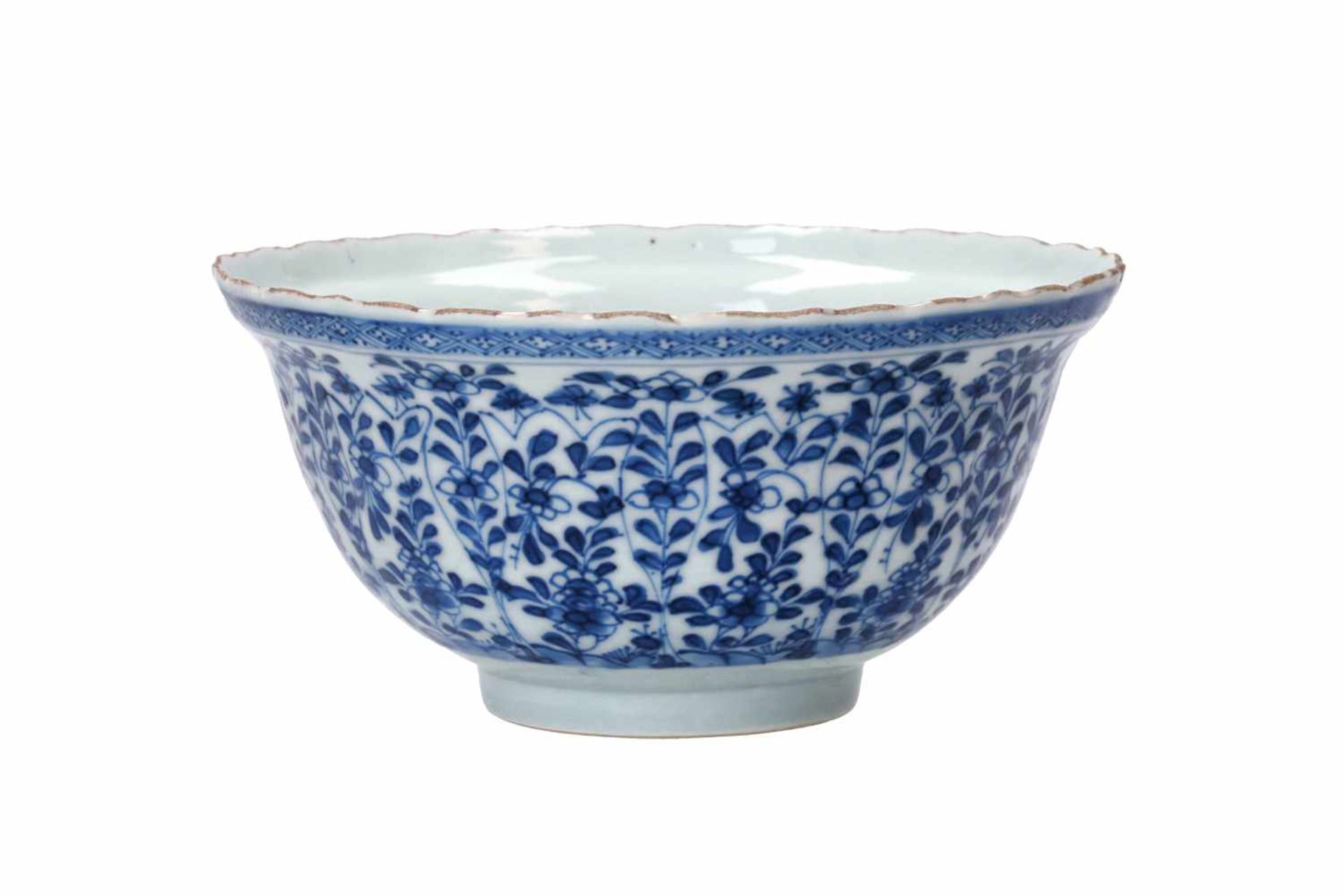 A ribbed blue and white porcelain bowl, decorated with flowers and figures in a garden. Unmarked.