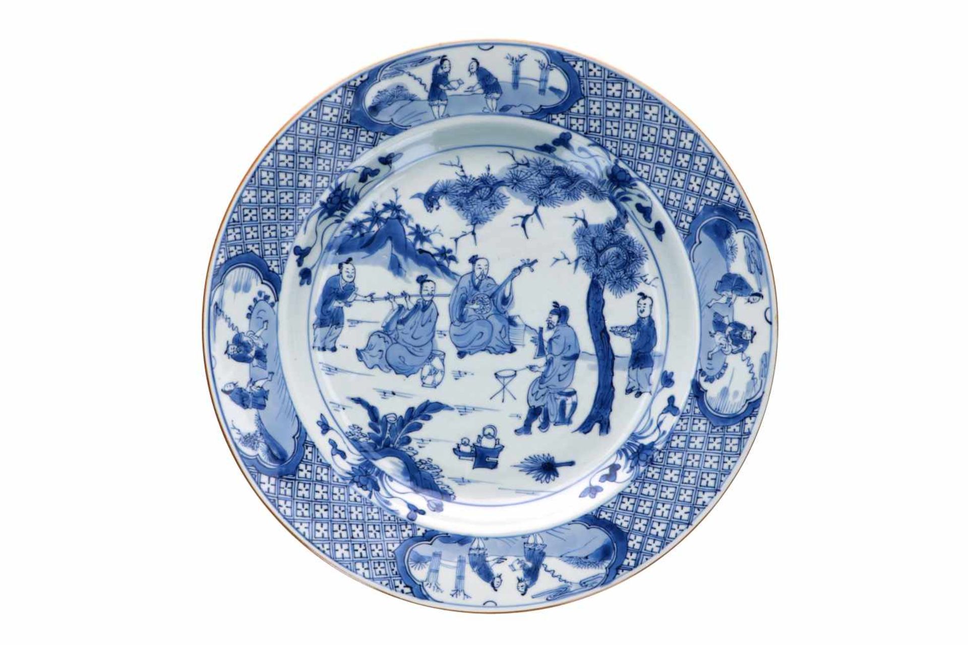 A blue and white porcelain charger, decorated with Taoist musicians and their servants in a