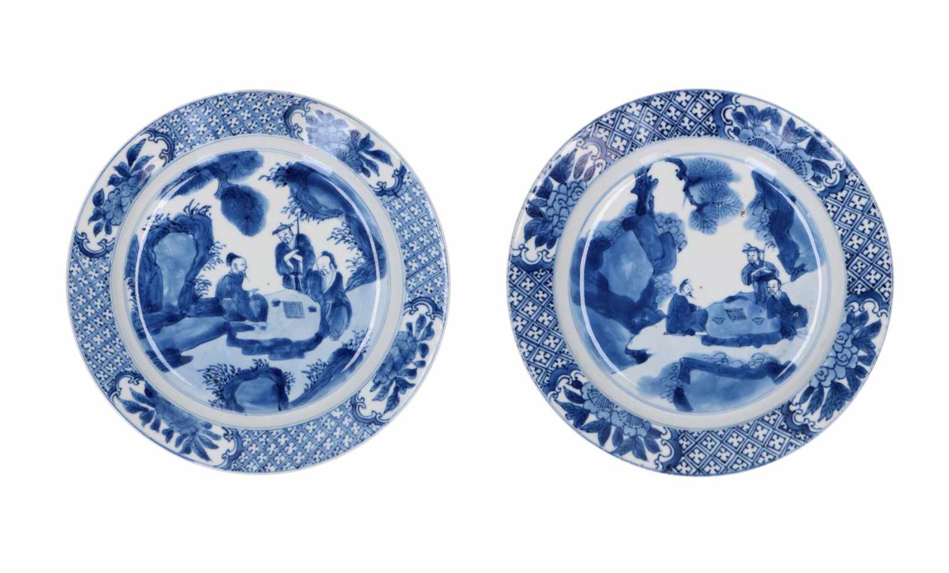 Two blue and white porcelain dishes, decorated with figures in a garden. Marked with 4-character