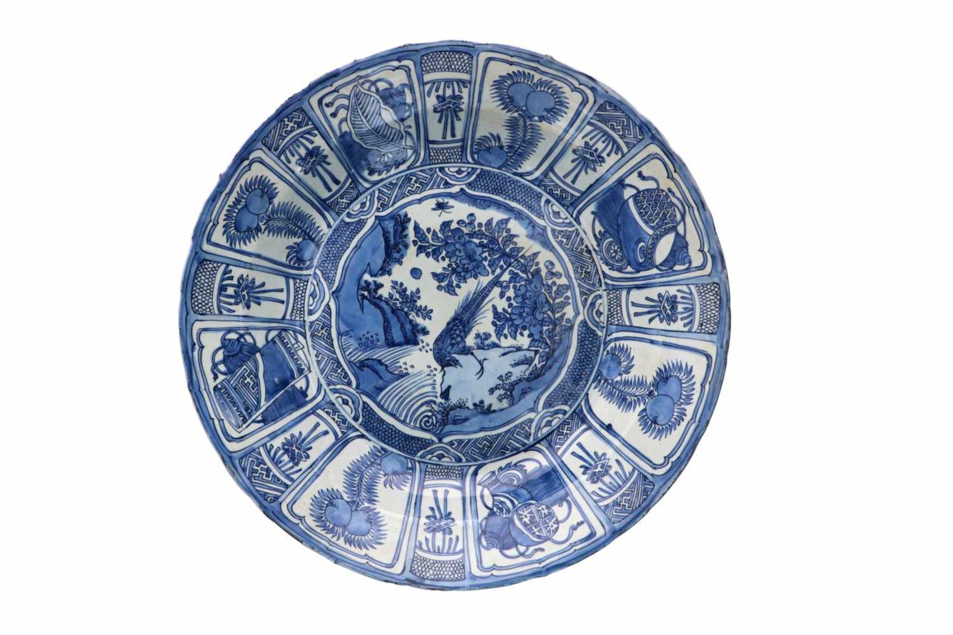 A blue and white 'kraak' porcelain deep charger, decorated with a silver pheasant, fruits,