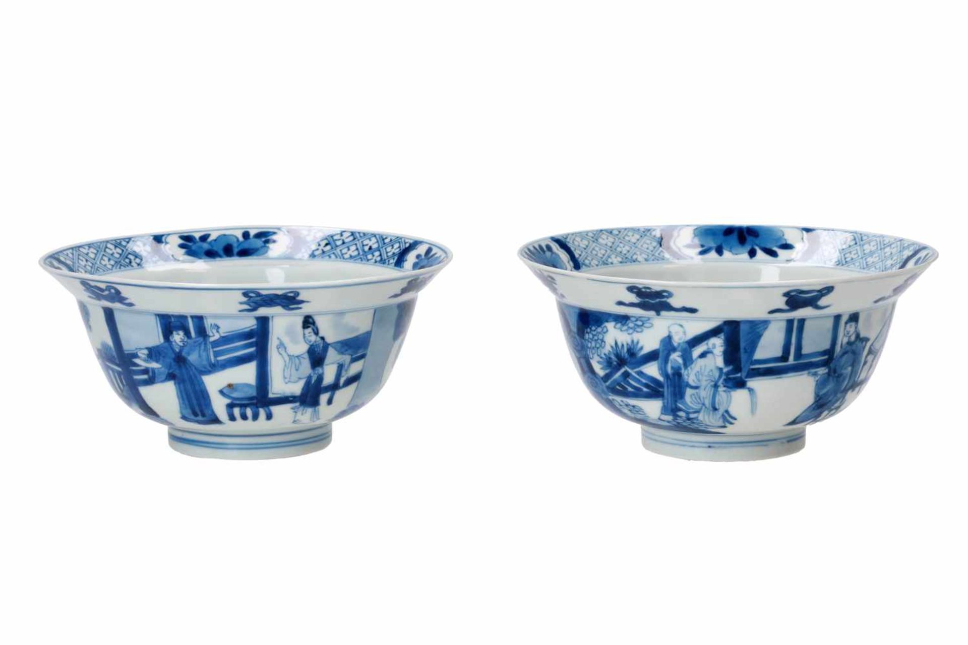 A pair of blue and white porcelain bowls, decorated with figures on a terrace, little boys and