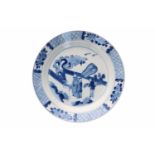 A blue and white porcelain dish, decorated with a dignitary with two servants and a crane on a