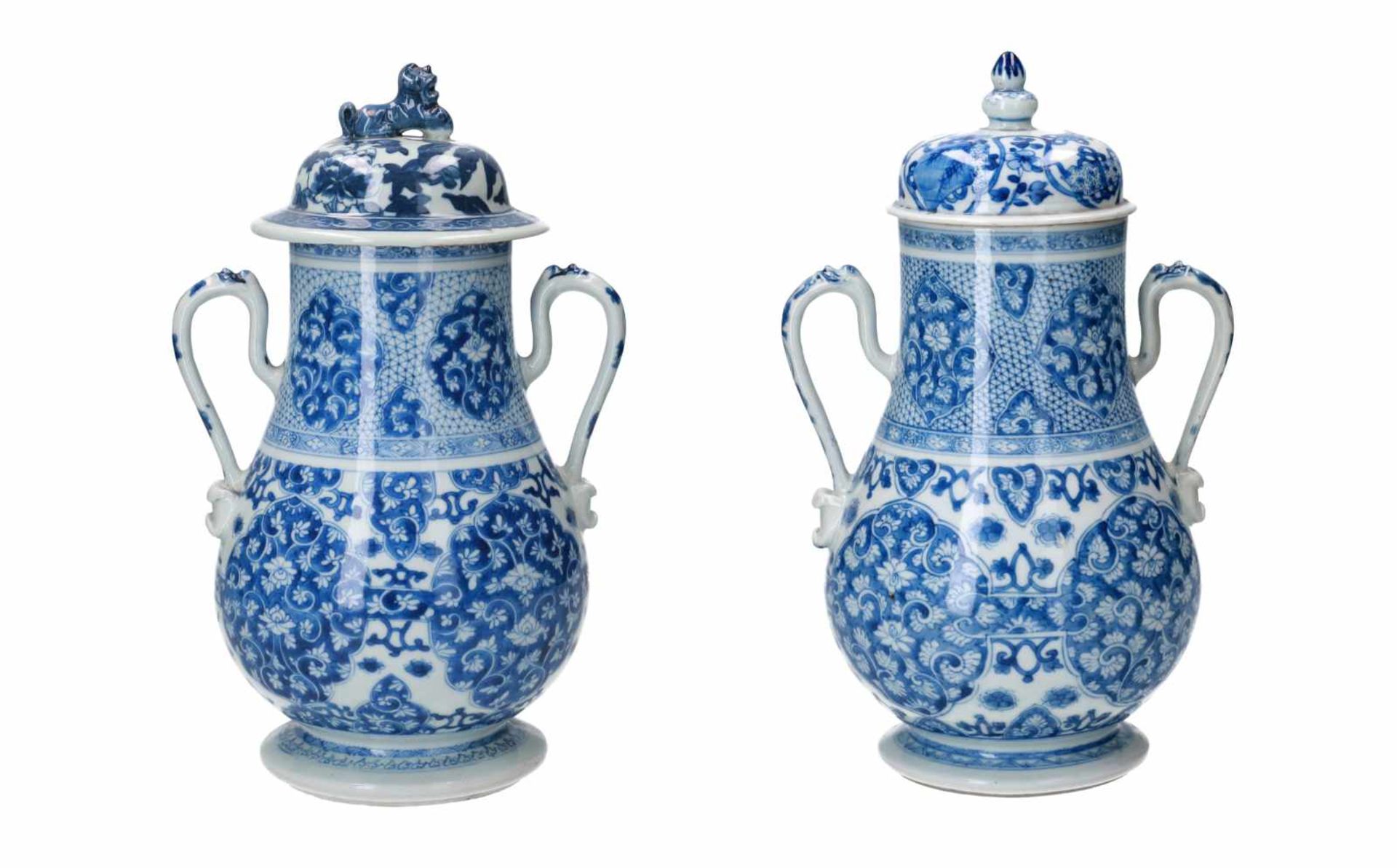 A pair of blue and white porcelain vases with two handles. Unmarked. Covers associated. China,