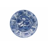 A blue and white porcelain charger, decorated with water birds and reserves depicting peaches and