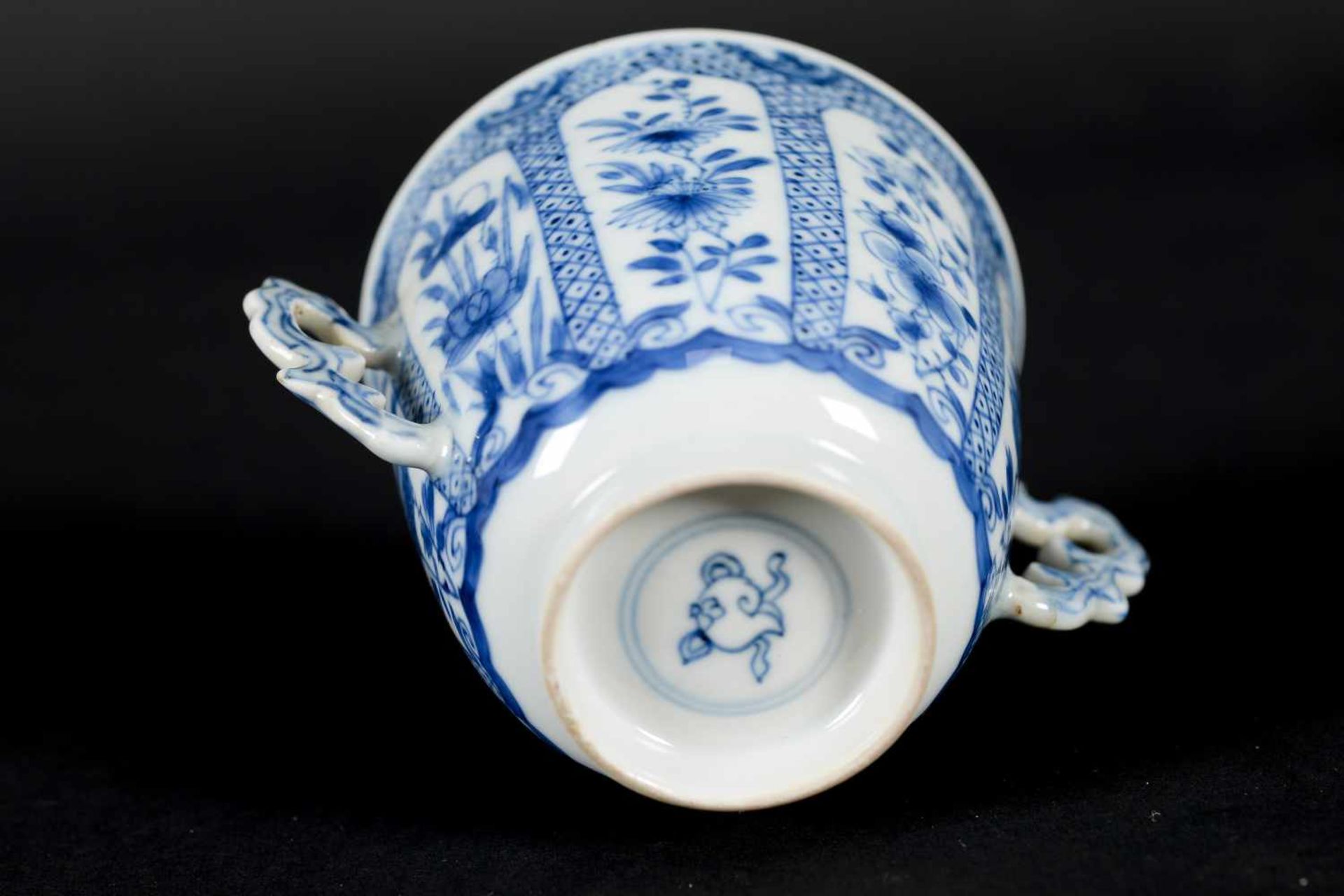 A blue and white porcelain lidded cup with two handles on a deep saucer, decorated with flowers. - Image 9 of 9